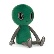Plush green toy alien with smiling face, big shiny black eyes and shiny silver black limbs on a white background