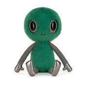Plush toy alien with green fur, smiling face, big shiny black eyes and shiny silver black limbs on a white background