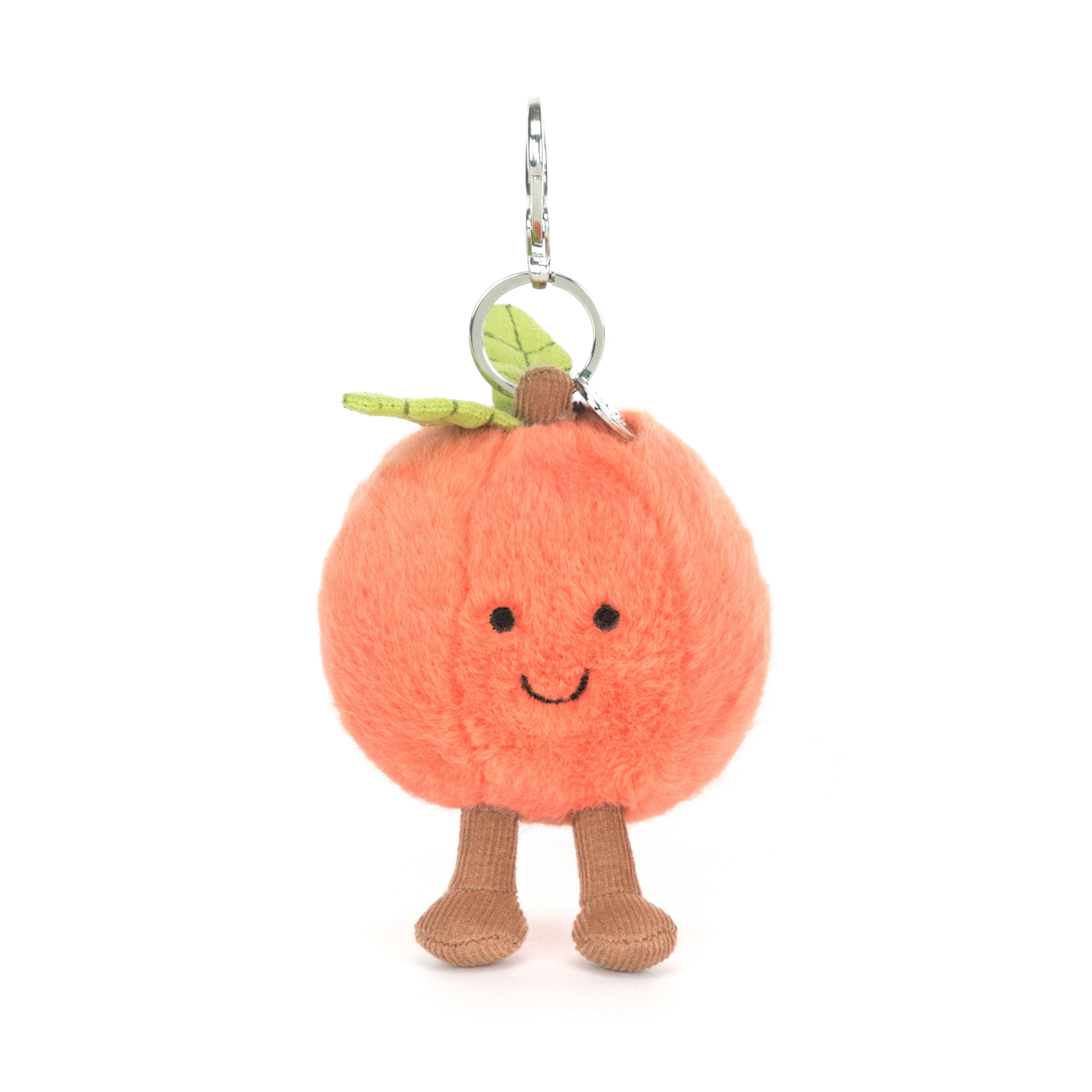 plush toy peach keychain with smiling face on white background