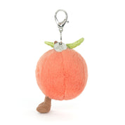 Plush peach keychain with legs and a clip on a white background
