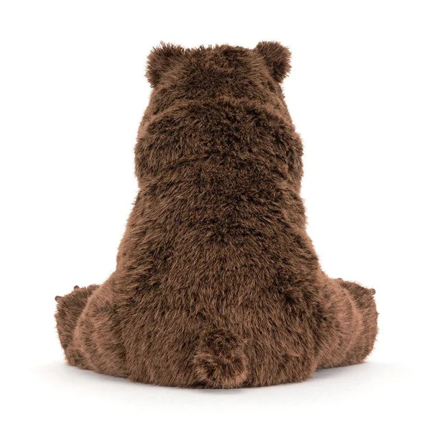 backview of A large jellycat brown plush stuffed bear toy sitting upright on a clean white background.