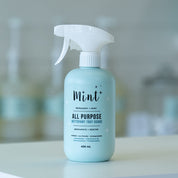 All-purpose cleaning spray bottle labeled 'Mint' on a blurred background