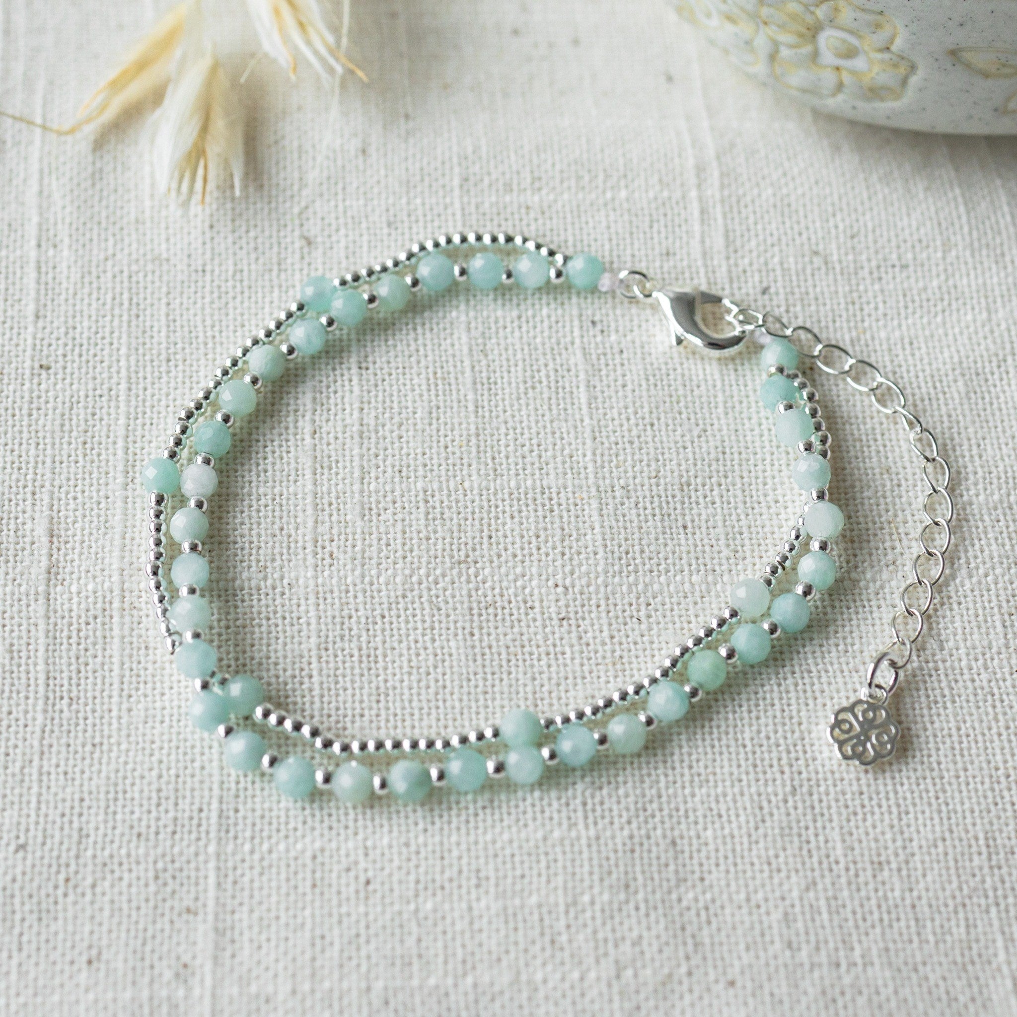 Turquoise beaded bracelet on a light fabric background