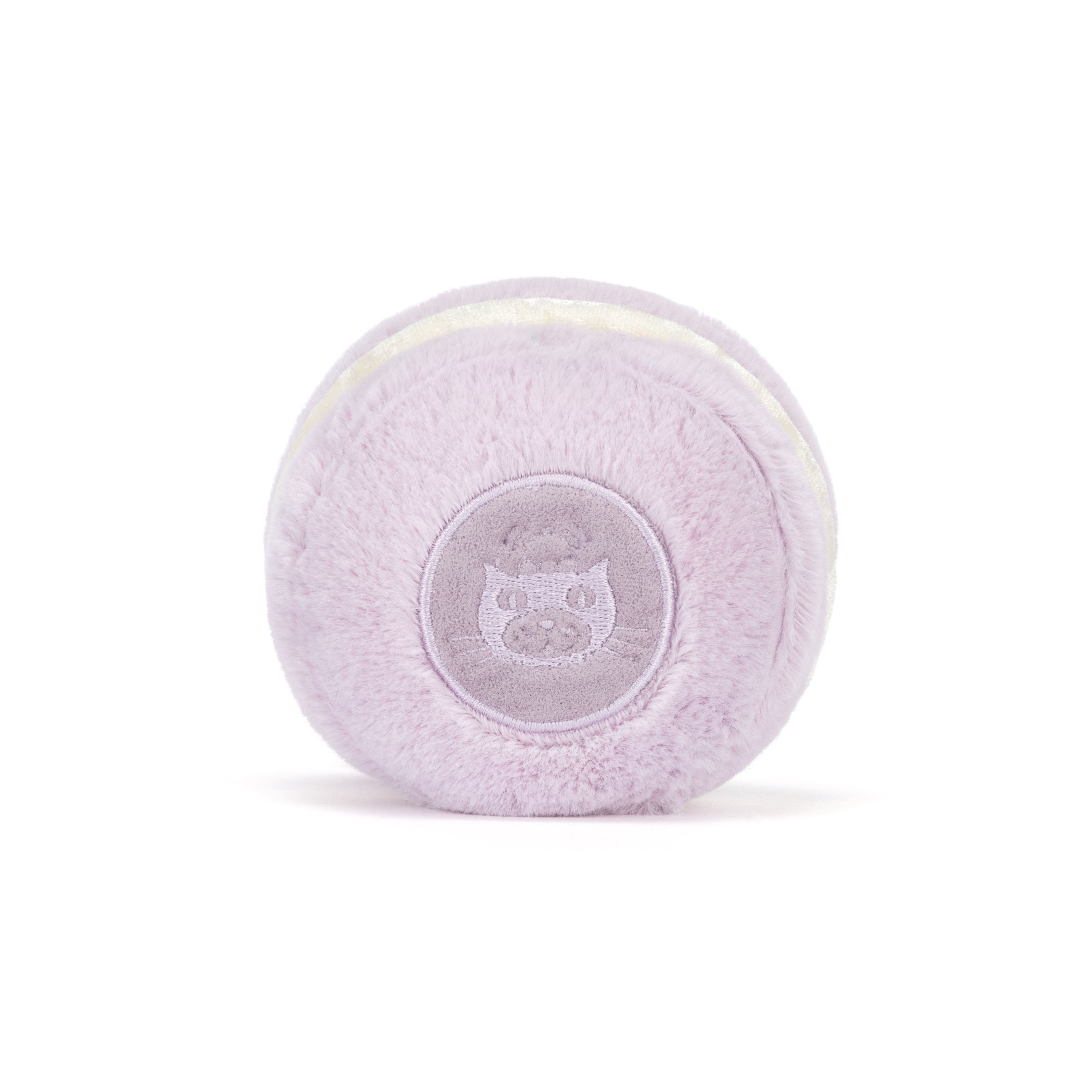Plush lavender macaron toy on white background