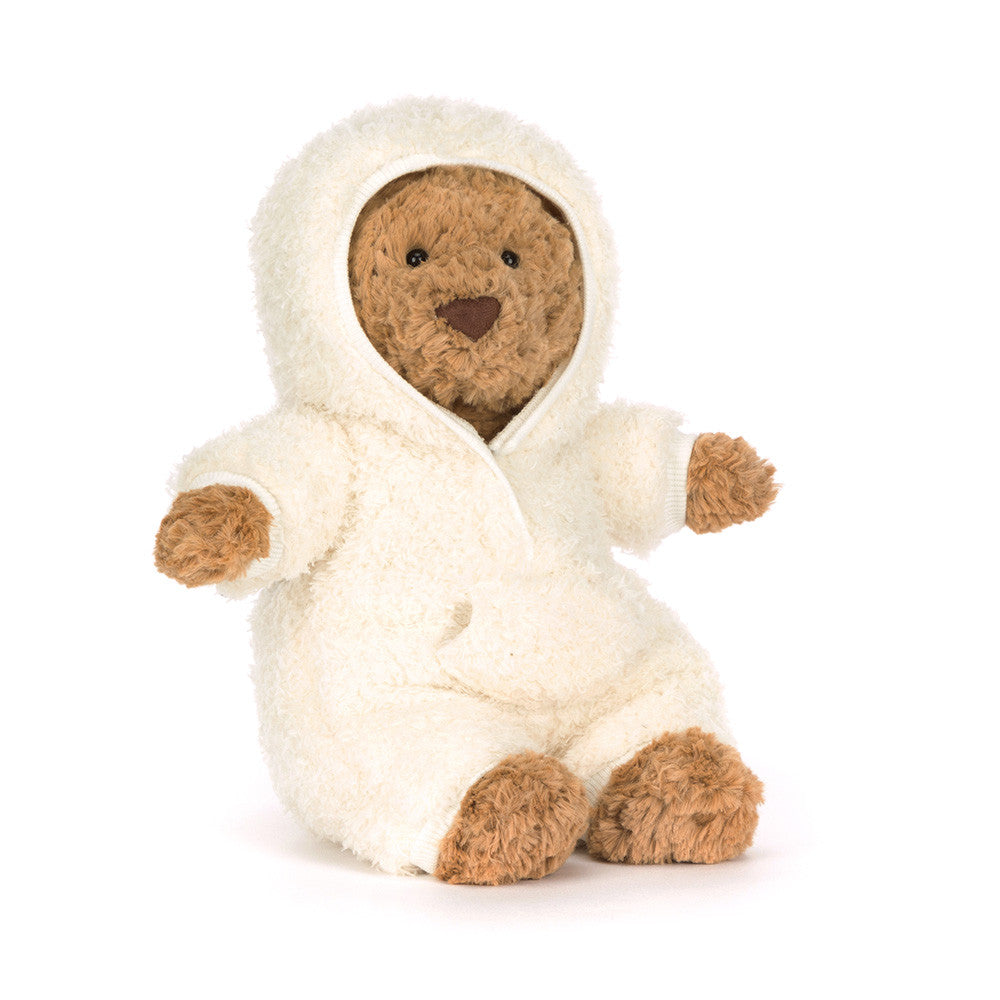 Brown bear plush toy in a white hooded outfit on a white background