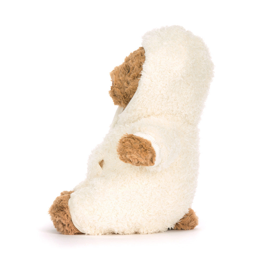 Plush brown bear toy in white hooded outfit on white background