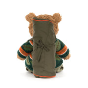 back view of Jellycat Bartholomew Bear in hiking outfit with leaf sweater and sleeping bag accessory on white background
