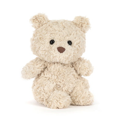 Small beige plush toy bear on white background