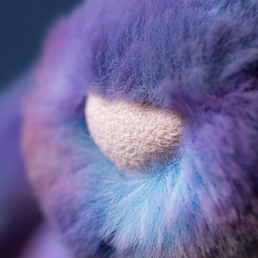close up of plush pink bunny nose with purple fur
