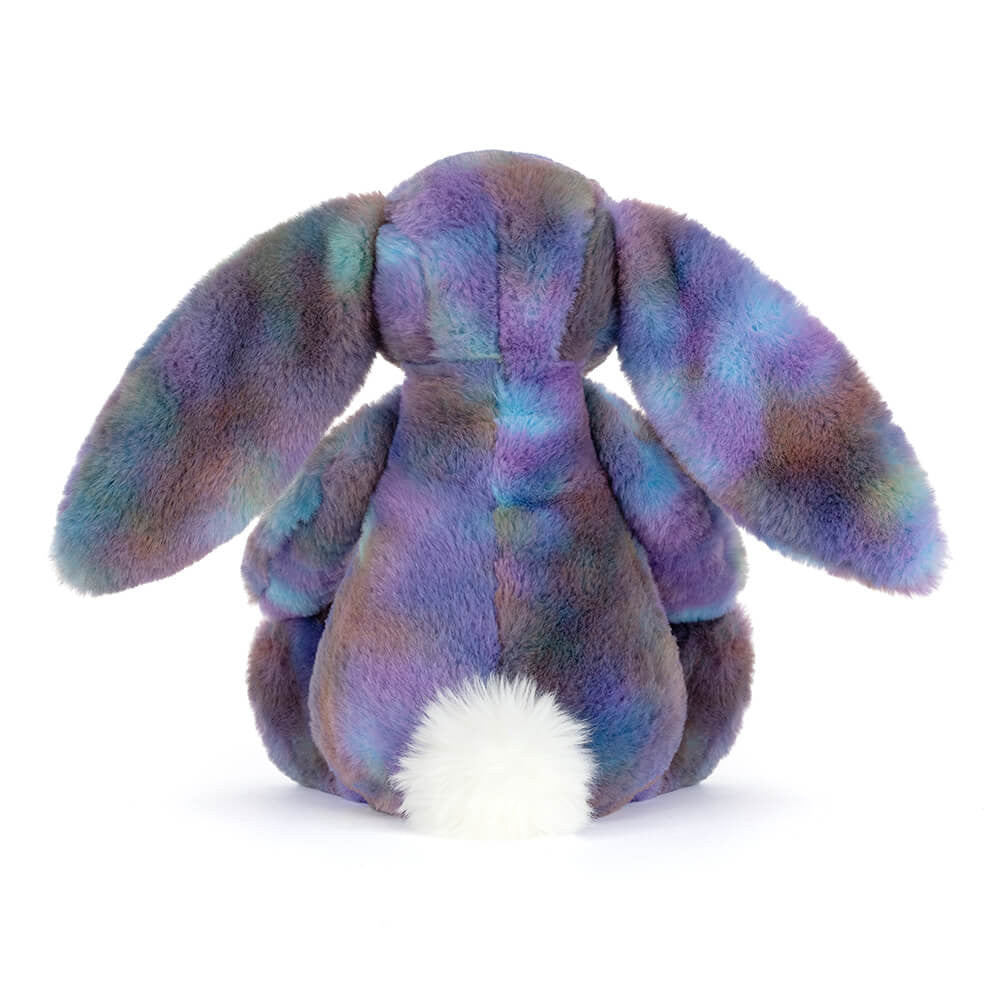 back view of plush toy bunny with purple galaxy style colouring with long ears and white fluffy tail on a white background