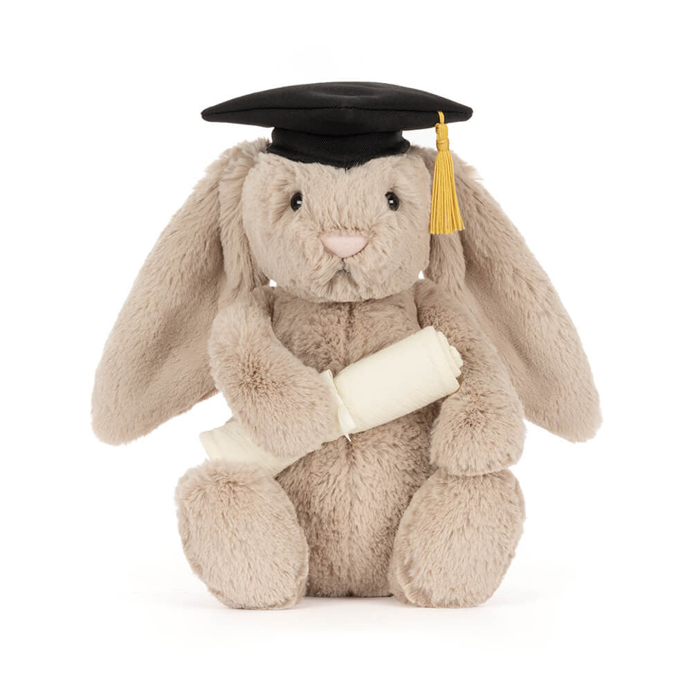 Plush toy rabbit wearing a graduation cap and holding a diploma on a white background