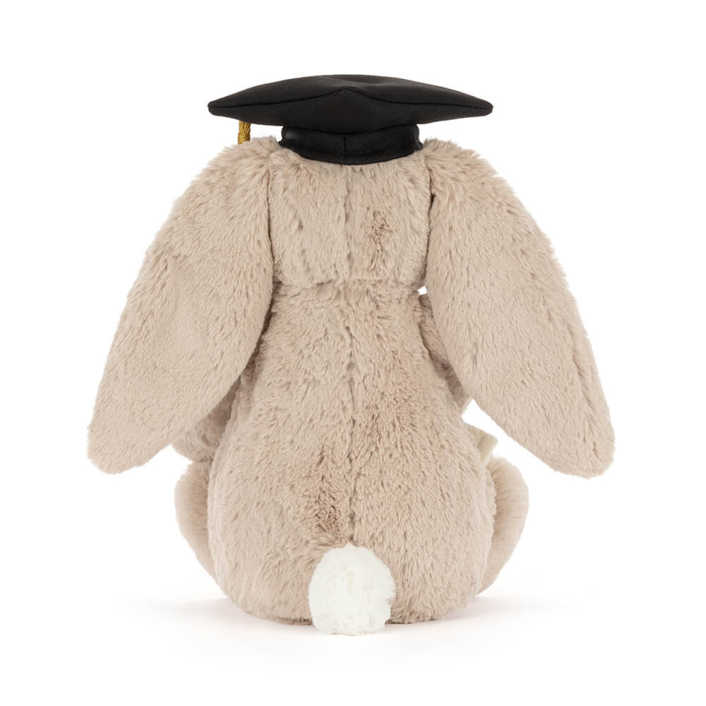 Plush bunny toy wearing a graduation cap on a white background