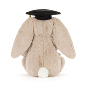 Plush bunny toy wearing a graduation cap on a white background