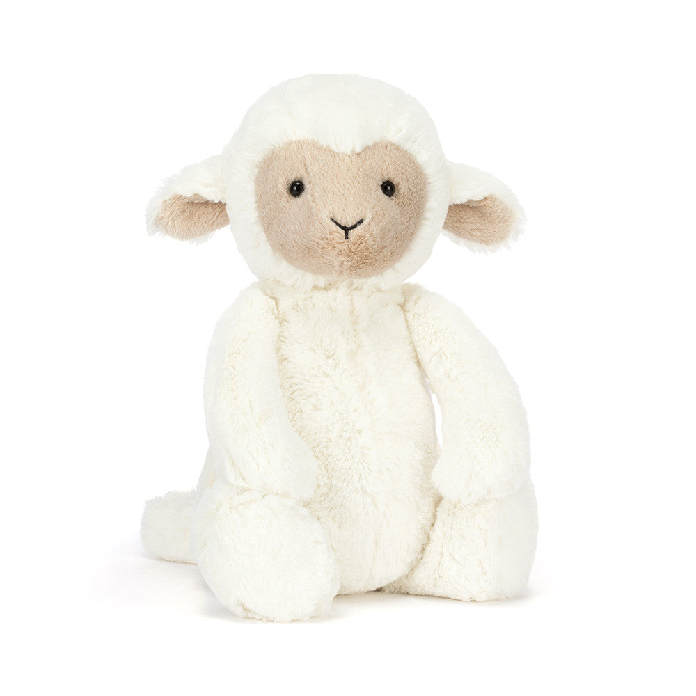Stuffed toy lamb with white fleece and beige face on a white background