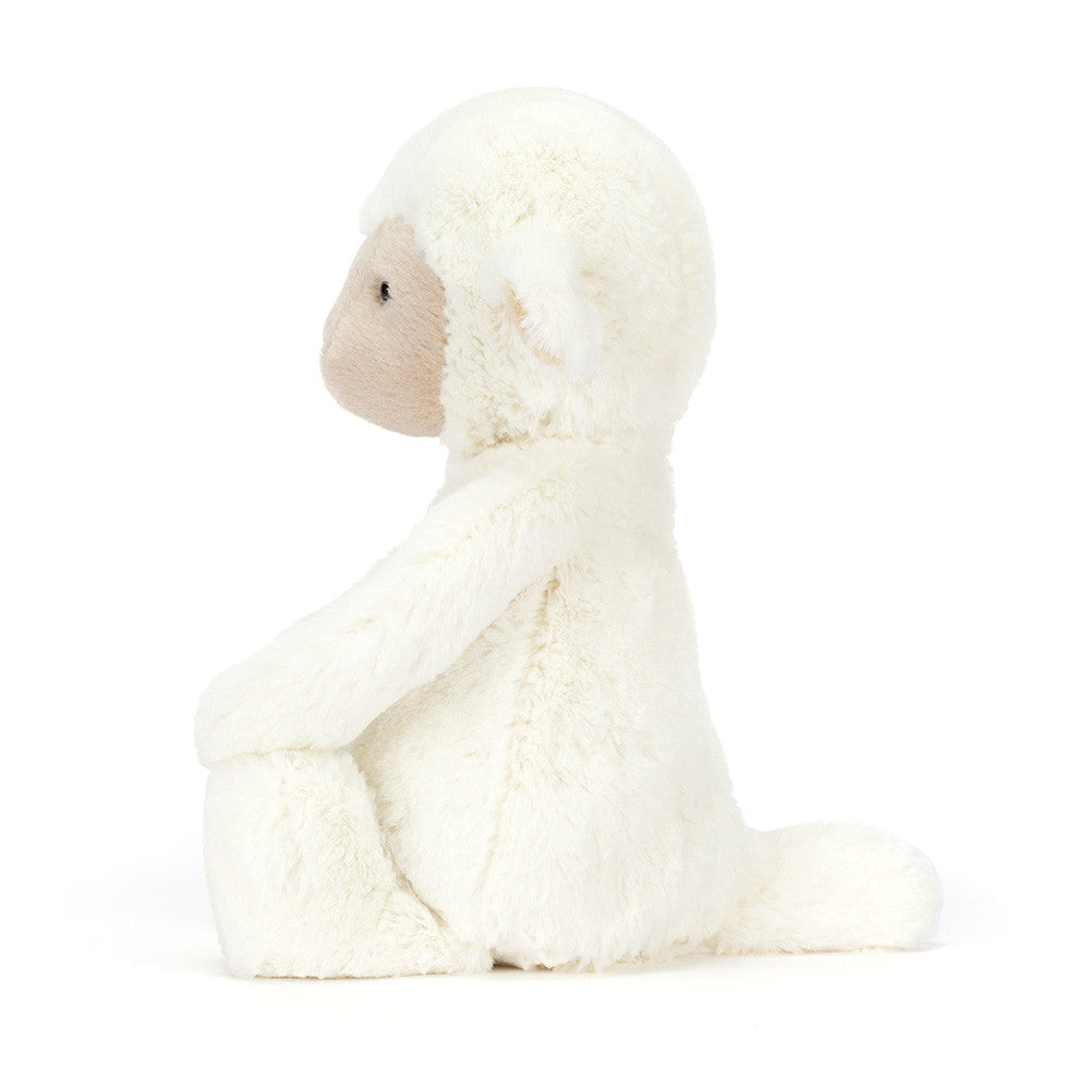 white plush lamb toy on white background