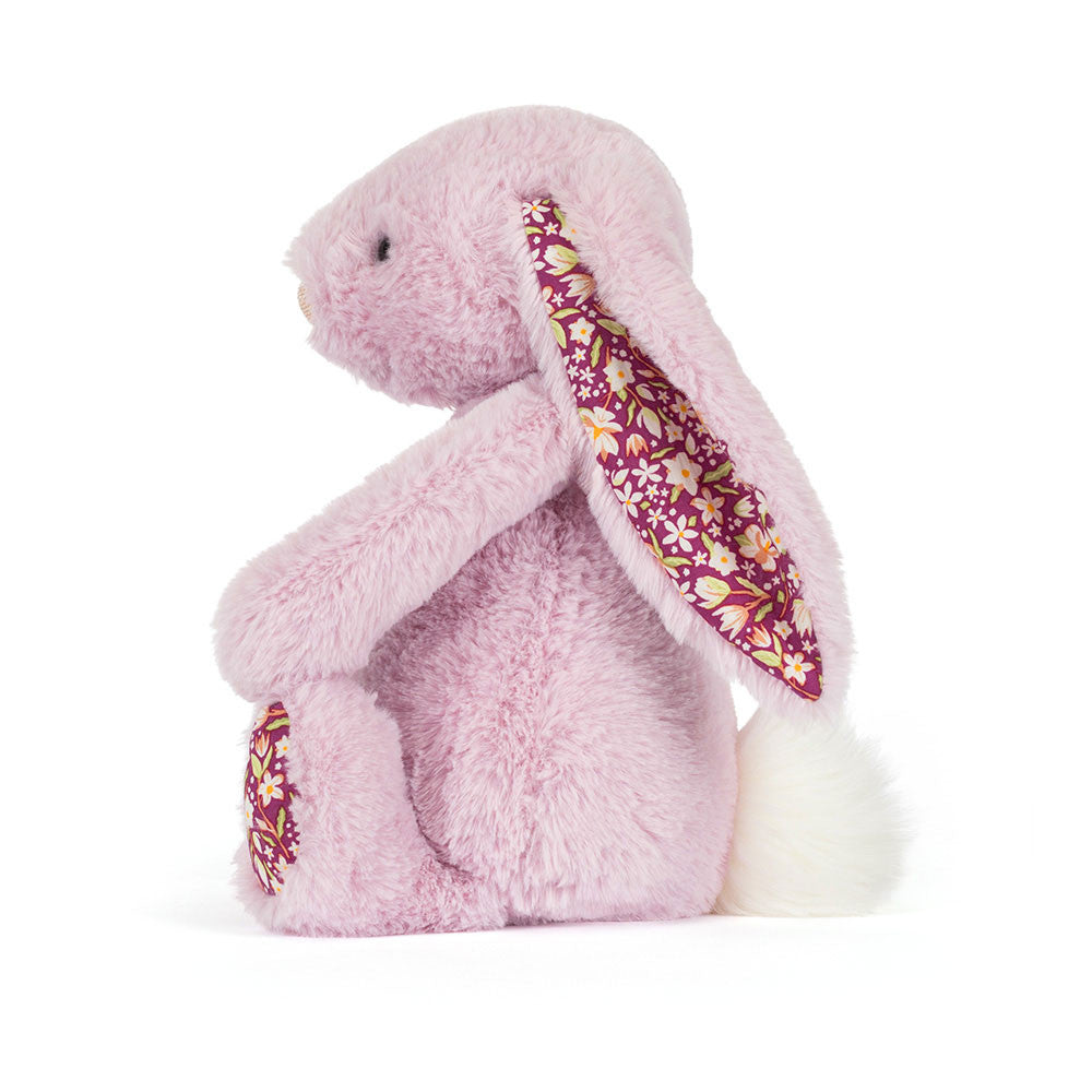 Pink plush bunny with floral pattern in ear  and feet on a white background