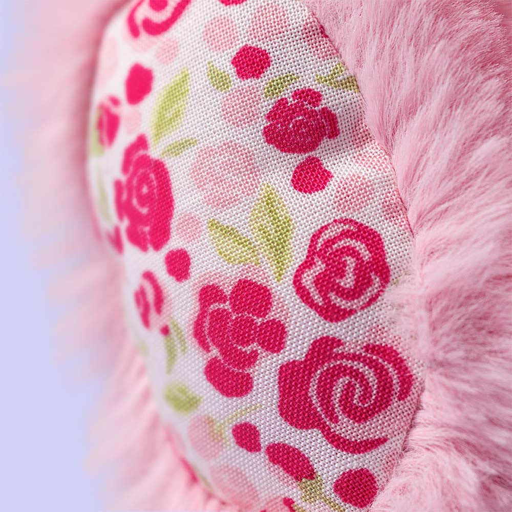 Close-up of a pink plush bunny with floral patterned details