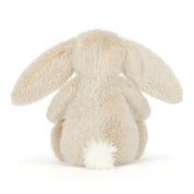 Fluffy beige bunny rabbit toy on a white background