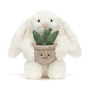 white bunny rabbit plush toy holding smiling potted plant on white background