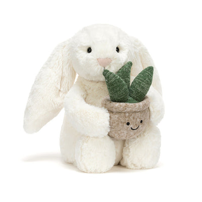 white bunny rabbit plush toy holding smiling potted plant on white background