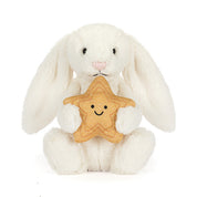 White bunny rabbit plush toy holding yellow smiling star on white background