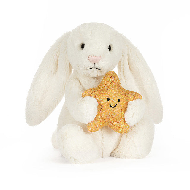 White bunny rabbit plush toy holding yellow smiling star on white background