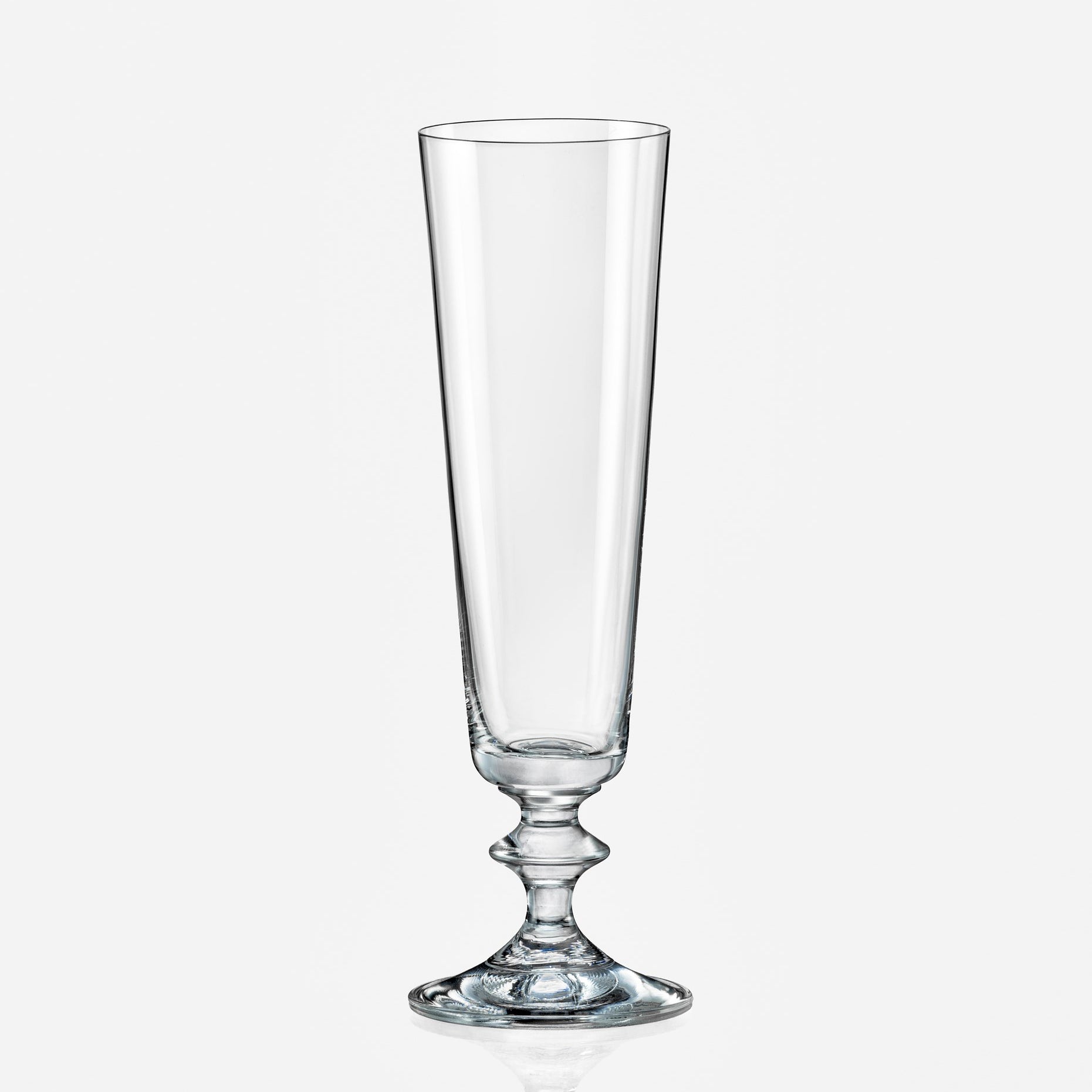 Clear glass with a pedestal base on a white background