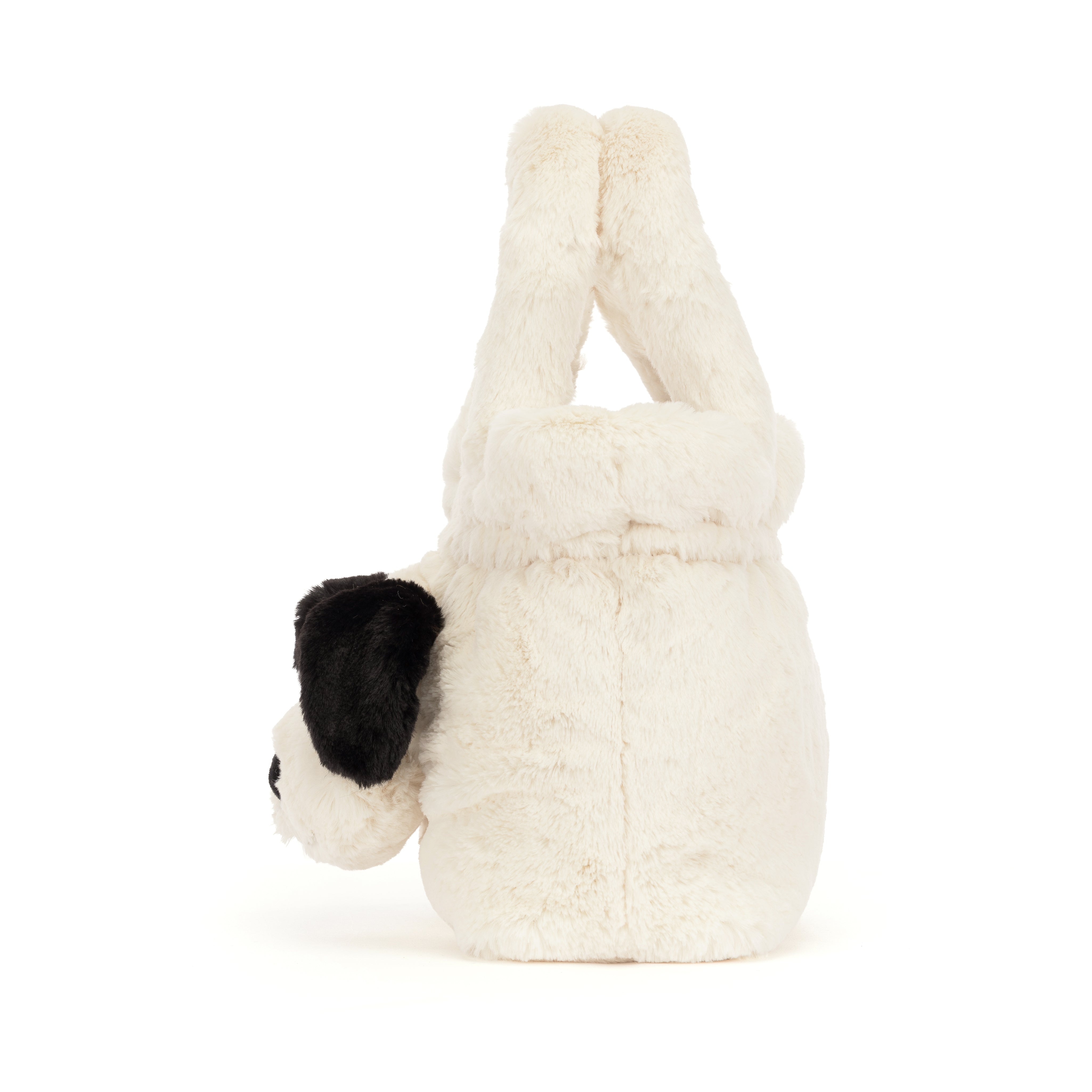 A plush dog-shaped handbag in off-white faux fur with black ears and a black nose, on a white background