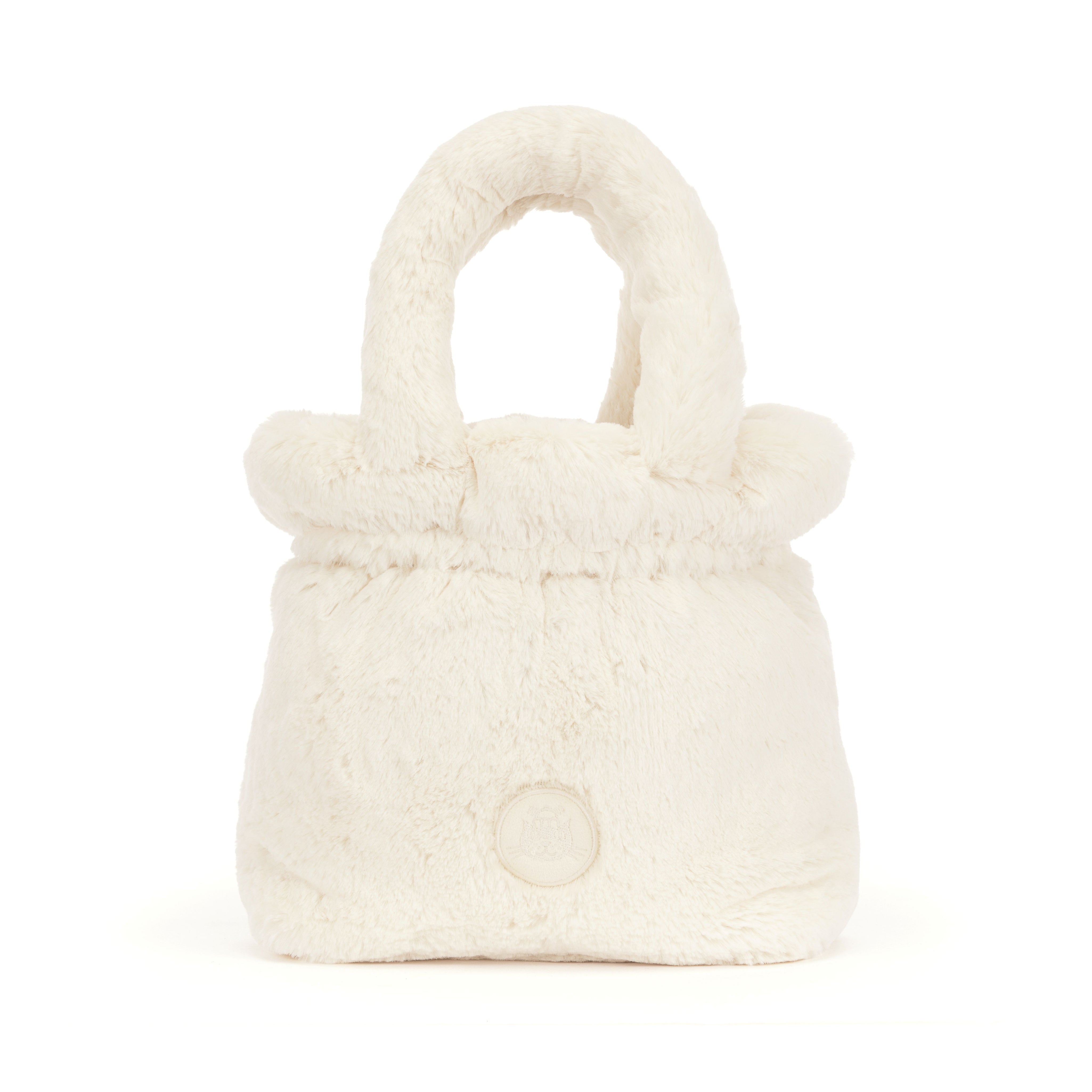 A shot of the back of a small cream plush faux-fur handbag with rounded top handles and a round logo on a white background
