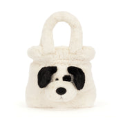 A plush dog-face handbag in cream faux fur with black ears, nose, and eyes, shown on a plain white background.