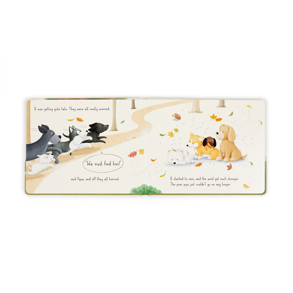 inside of Book by jellycat with cartoon dogs around a tree, titled 'Munro in the Middle'.