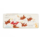 inside of Book by jellycat with cartoon dogs around a tree, titled 'Munro in the Middle'.