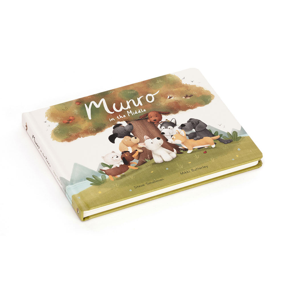 cover of Book by jellycat with cartoon dogs around a tree, titled 'Munro in the Middle'.