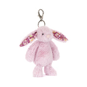 Pink plush bunny keychain with floral ears on a white background