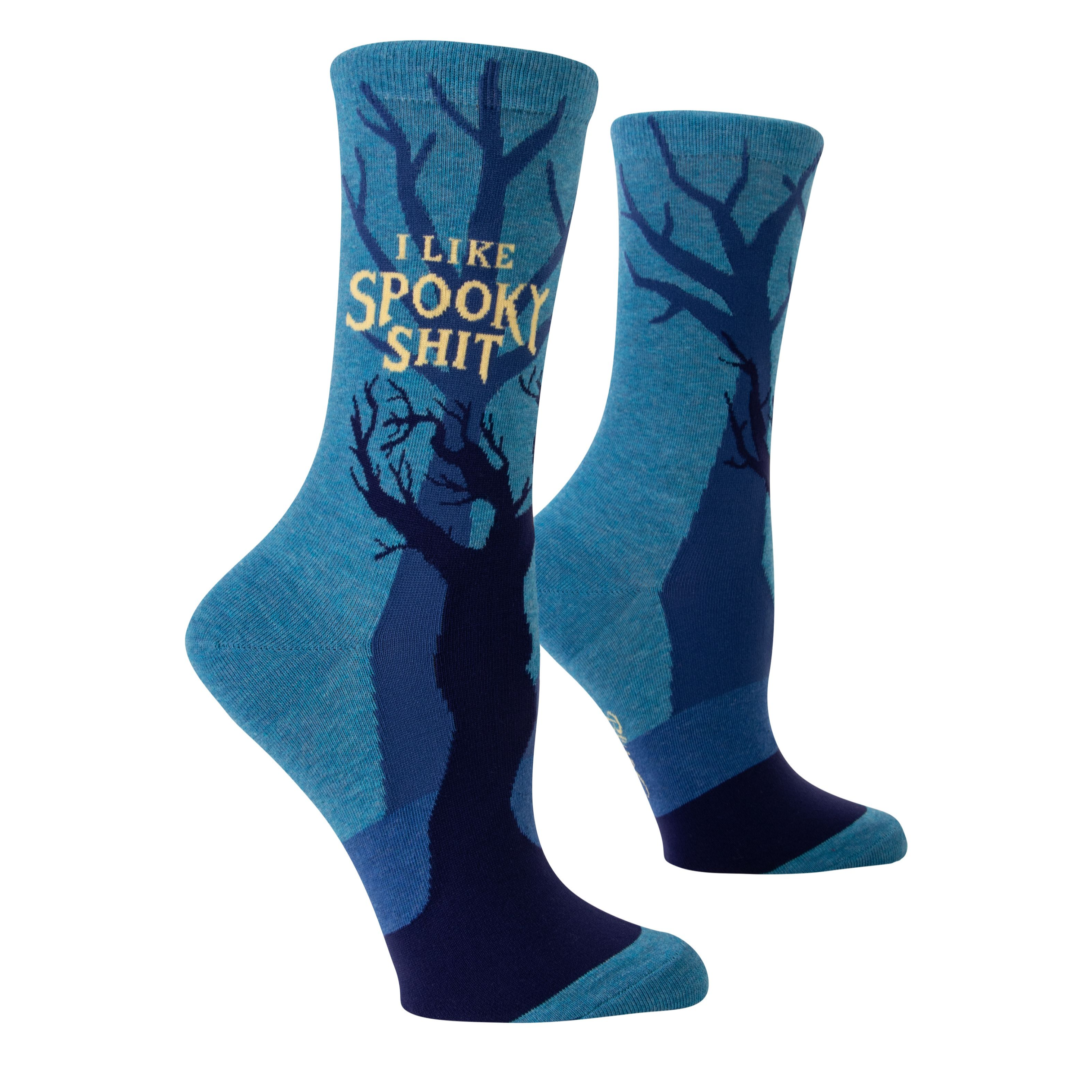blue socks with shadow trees in background with yellow writing on top that says i like spooky shit