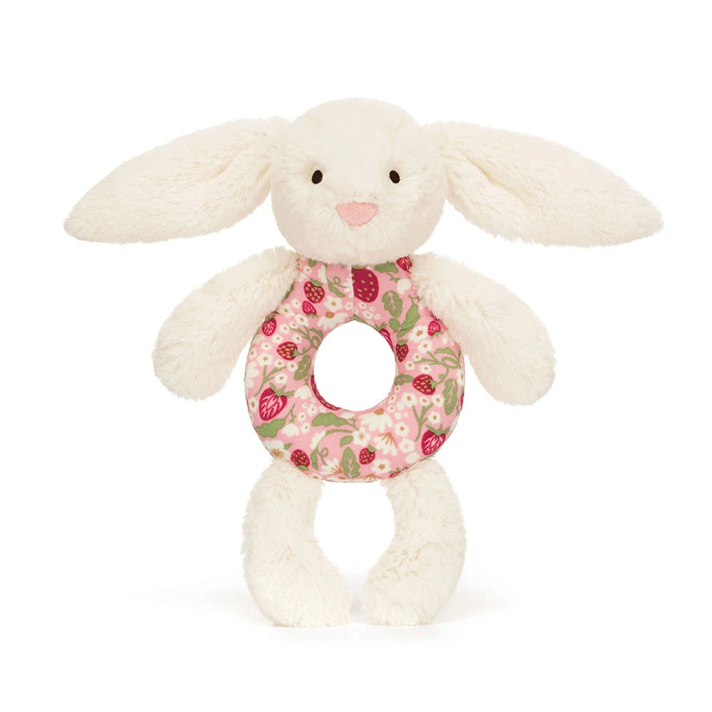 Plush bunny baby rattle toy from jellycat with a floral ring on a white background