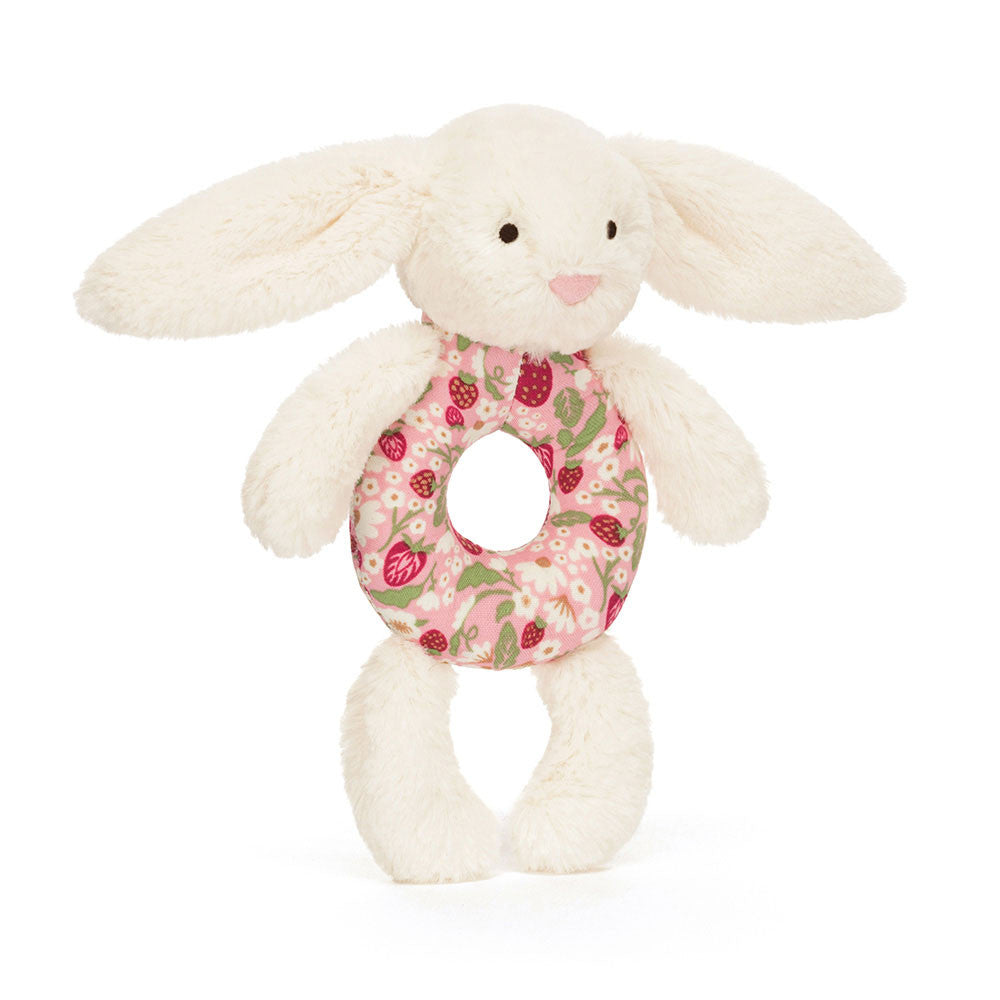 Plush bunny baby rattle toy from jellycat with a floral ring on a white background