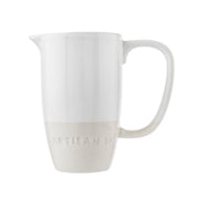 White ceramic pitcher with 'Artisan' branding on a white background