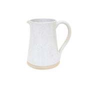 White ceramic pitcher with speckled texture on a white background