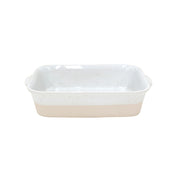 Rectangular ceramic baking dish with speckled white and beige design on a white background