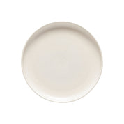 Round ceramic plate with a speckled beige pattern on a white background