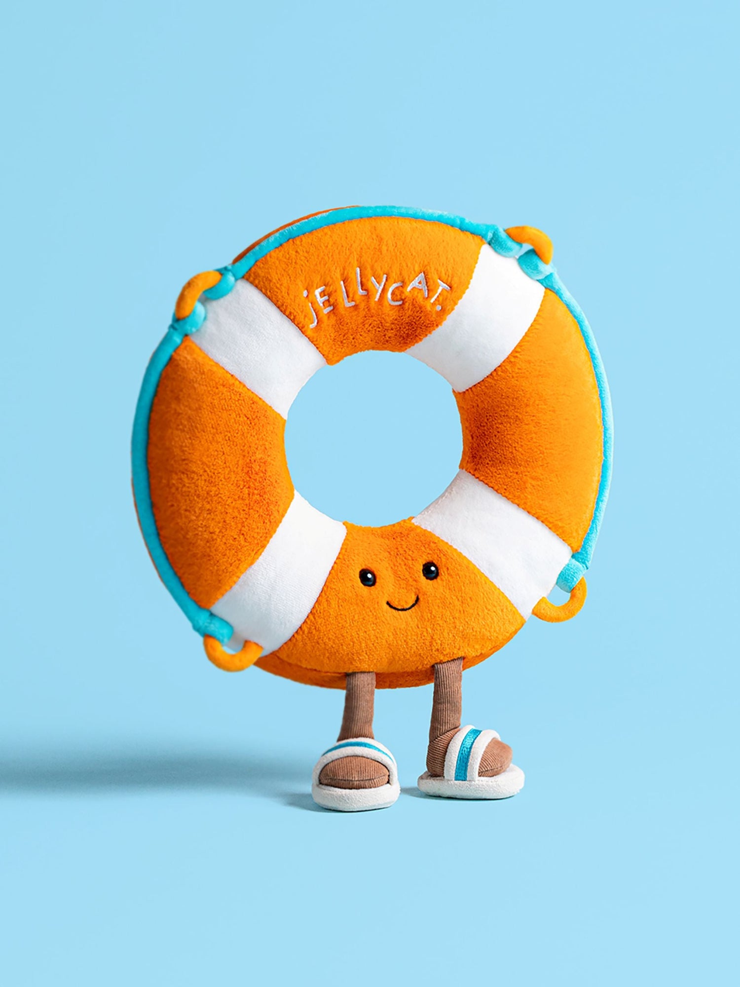 Jellycat orange white and blue plush toy life preserver or life ring with a smiling face on a blue background