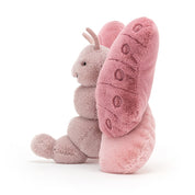 side view of fuzzy soft pink beatrice butterfly stuffed plush toy made by jellycat