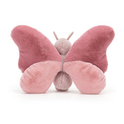 back view of fuzzy soft pink beatrice butterfly stuffed plush toy made by jellycat