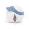 side view of stuffed plush toy of white golf ball with light blue visor hat and black smiley face made by jellycat
