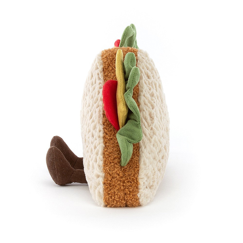 side view of fuzzy soft stuffed plush toy triangle sandwich half with cheese, tomatoes, lettuce made by jellycat
