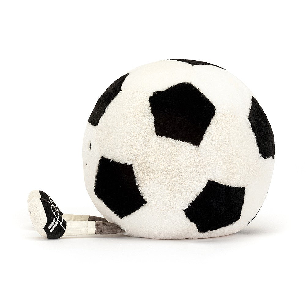 side view of stuffed plush toy of a black and white soccer ball with cleats and black smiley face made by jellycat