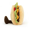 side view of stuffed plush toy of a taco with tomato, lettuce, cheese and protein made by jellycat