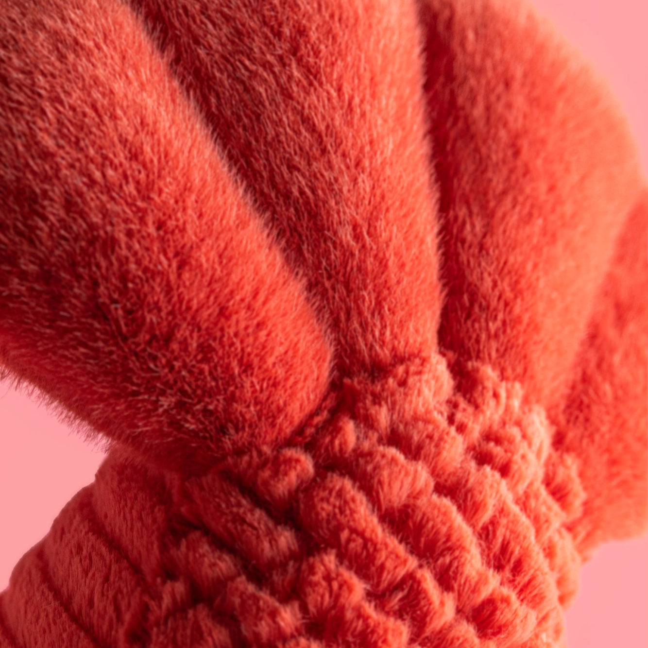 close up of Plush jellycat lobster tail on a pink background