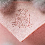 detail shot of embroidered jellycat logo pink thread on pink background